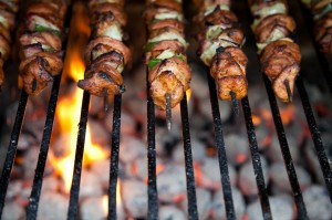 skewers of food on hot coals